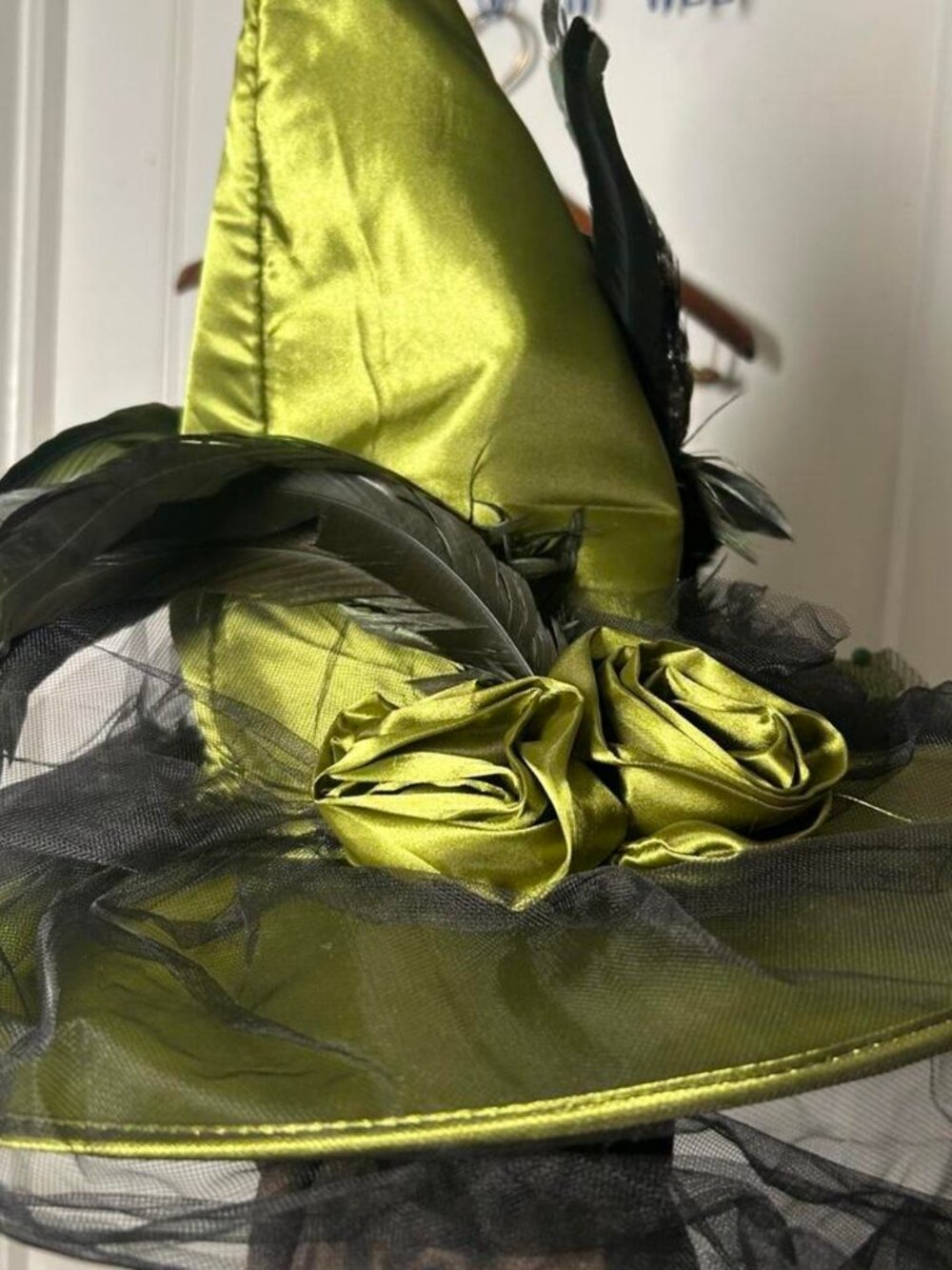 Green witch hat with black feathers and tulle